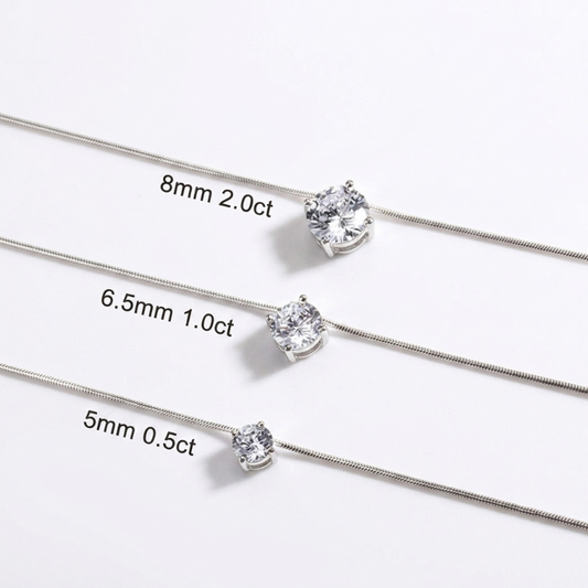 Three silver-toned chain necklaces with single clear gemstones are shown on a white background, each labeled with size and carat information: 8mm 2.0ct, 6. - Fashlot