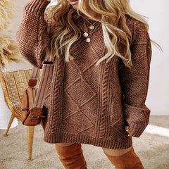 Person wearing a brown cable knit sweater and tan boots indoors. - Fashlot
