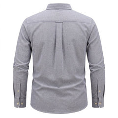 A men's long-sleeve button-down shirt shown from the back, featuring a heather gray fabric, a vertical pleat down the center back, and gold-tone button details on the cuffs. - Fashlot 