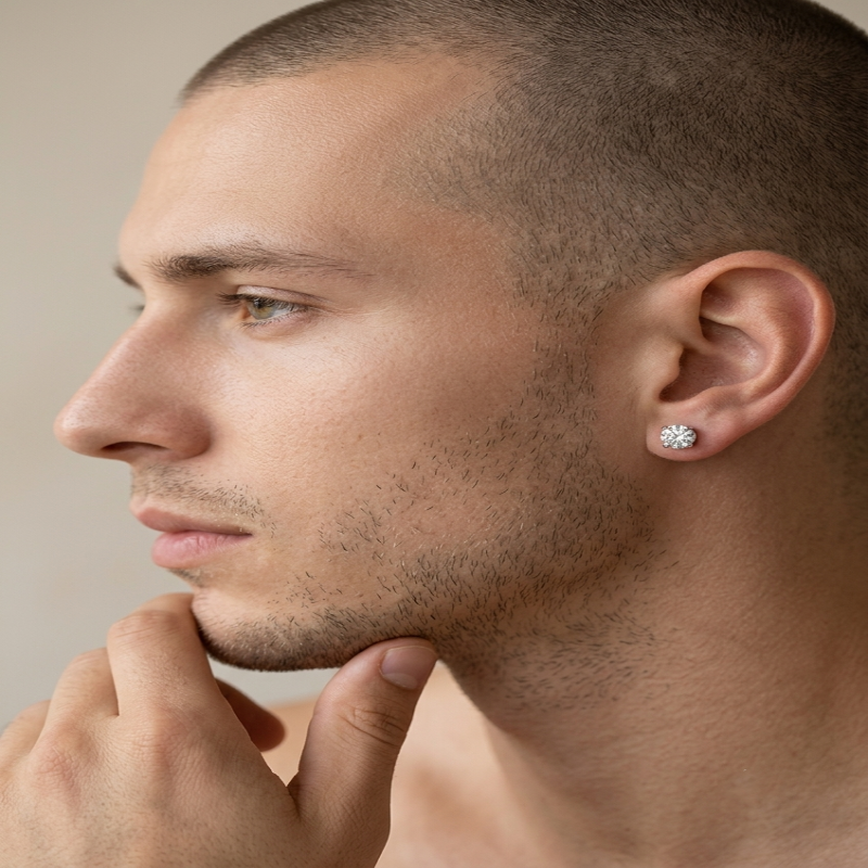 Close-up side profile of a man wearing a small silver-toned flower-shaped stud earring in his earlobe. - Fashlot