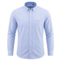 A light blue and white vertically striped long-sleeve button-down shirt with a chest pocket, displayed on a clean white background. - Fashlot 
