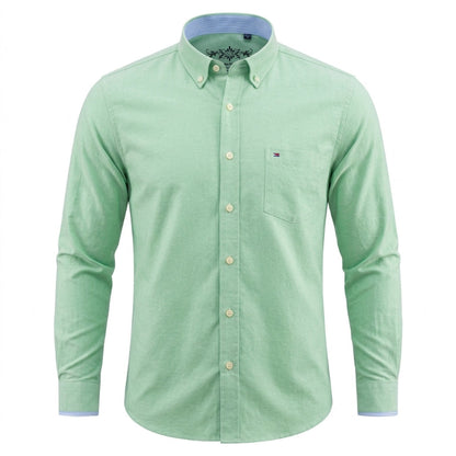 A light green long-sleeve button-down shirt with a chest pocket and a small Tommy Hilfiger flag logo on the left chest, shown on a plain white background. - Fashlot