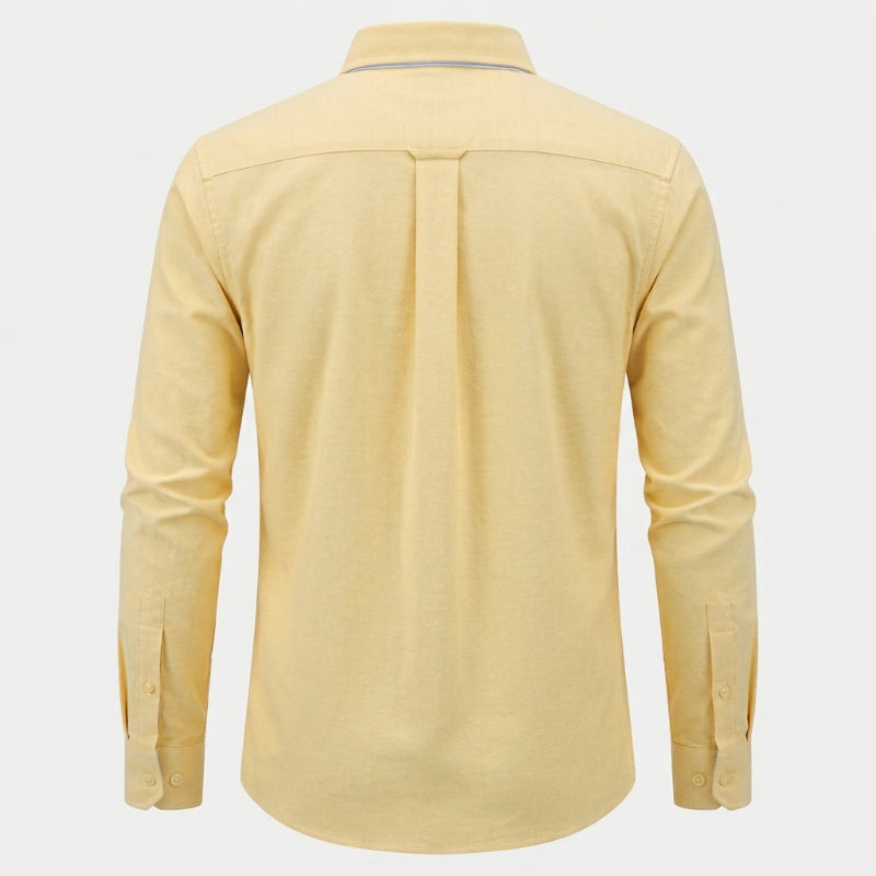 A pale yellow long-sleeve button-up shirt shown from the back, featuring a central pleat and button cuffs, displayed on a light gray background. - Fashlot