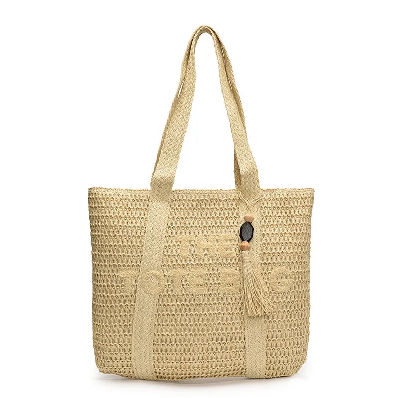 Beige woven crochet straw tote bag with wooden bead and tassel charm, standing on white background - Fashlot