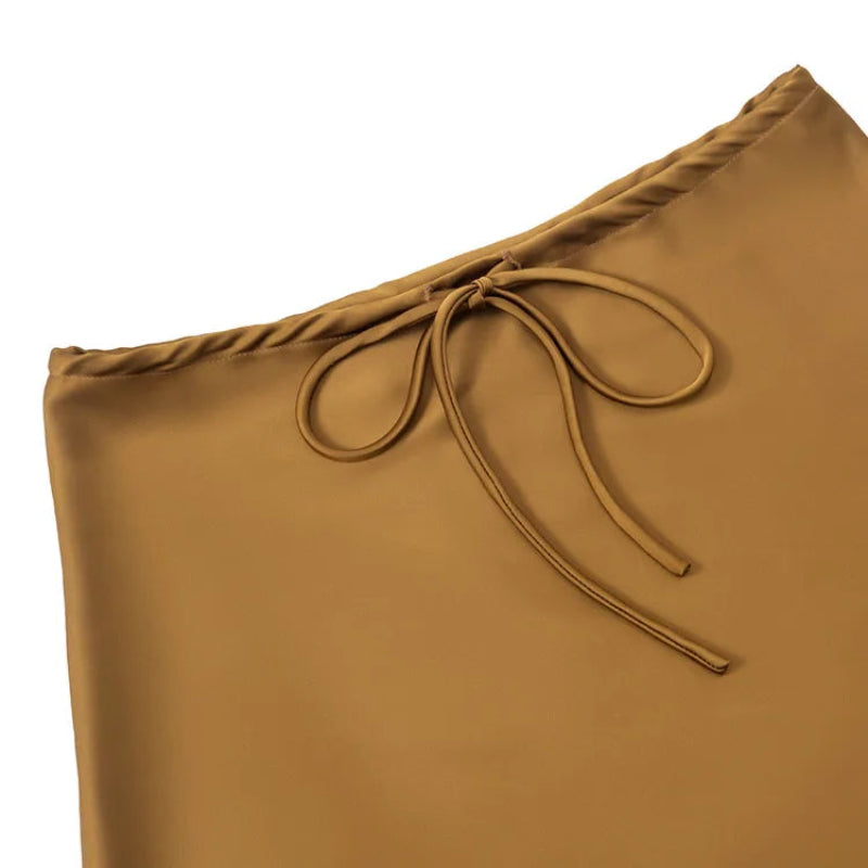 gold high waist skirt with a tie detail on a white background