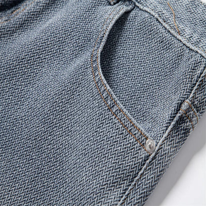 Close-up of blue denim fabric with a button and stitching detail. - Fashlot