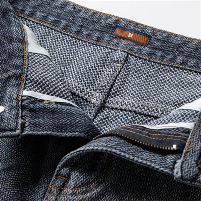 Close-up of a pair of blue jeans with a brand label on a white background