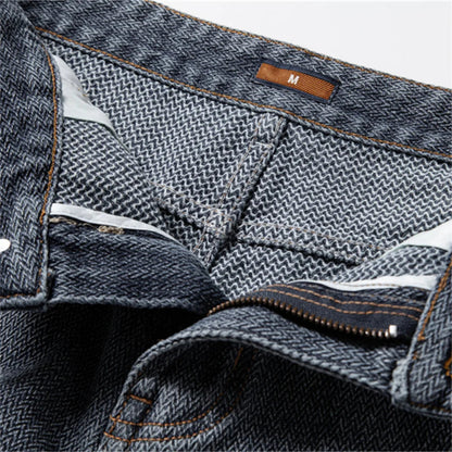 Close-up of a pair of blue jeans with a brand label on a white background