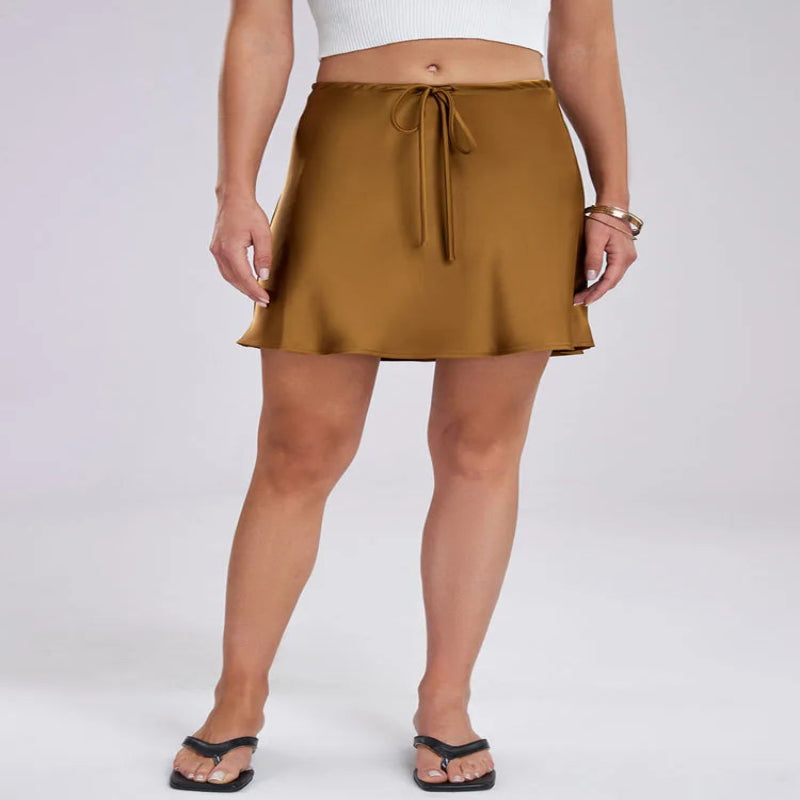 Person wearing a gold skirt on a white background - Fashlot