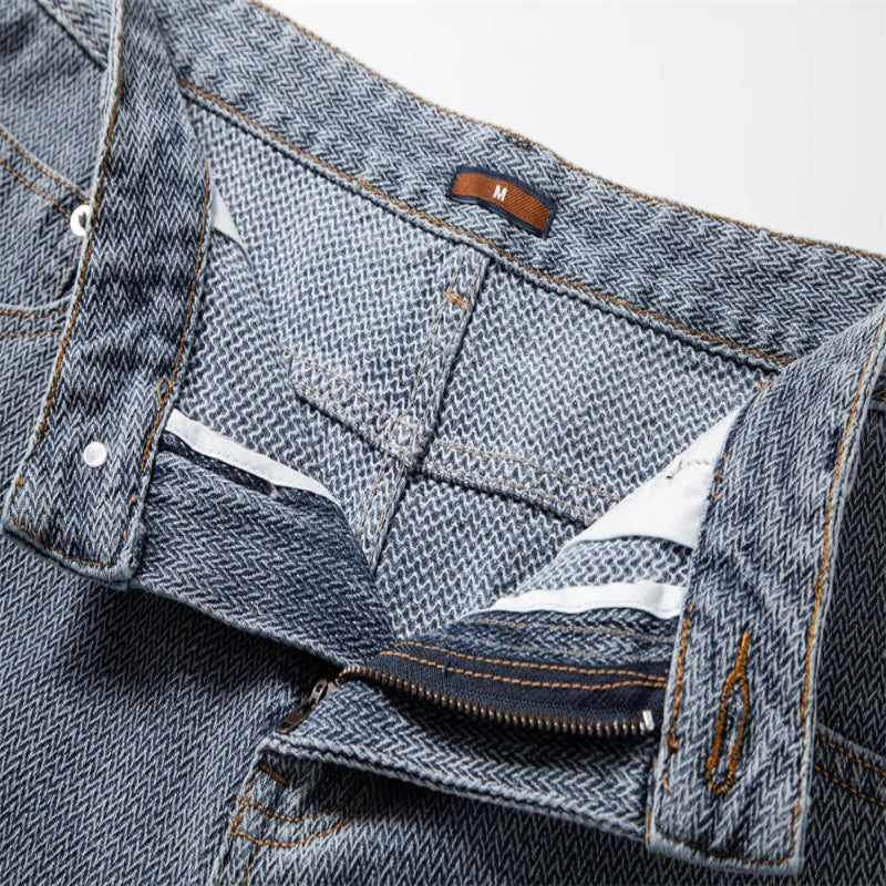 Close-up of a folded pair of blue jeans with brand label. - Fashlot