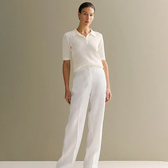 Woman wearing a off white blouse and pants against a plain background - Fashlot
