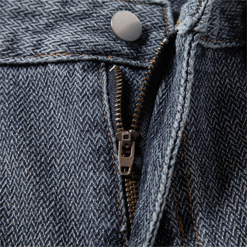 Close-up of a blue denim jacket zipper and button - Fashlot