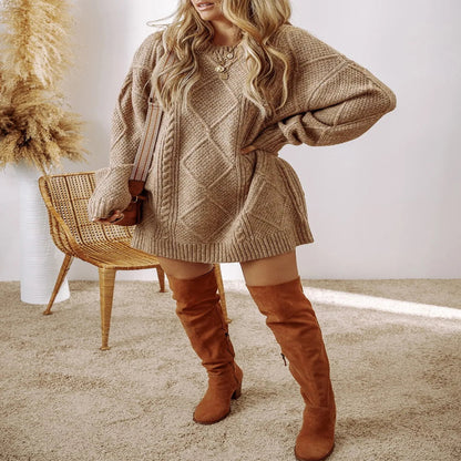 Person wearing a beige cable knit sweater and brown knee-high boots in a minimal indoor setting. - Fashlot