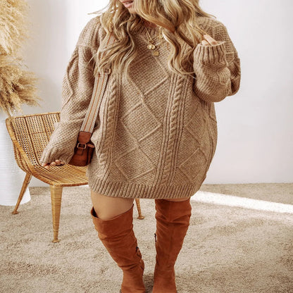 Woman wearing a brown cable knit sweater dress with brown knee-high boots in a minimalistic setting. - Fashlot