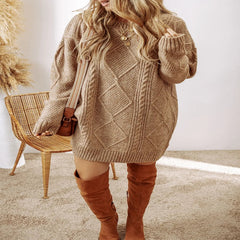 Woman wearing a brown cable knit sweater dress with brown knee-high boots in a minimalistic setting. - Fashlot