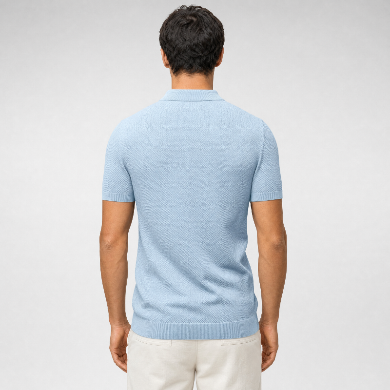 A man viewed from the back wearing a light blue short-sleeve knit polo shirt and off-white trousers, set against a neutral light gray studio background. - Fashlot